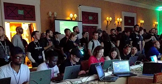 Attendees at a cybersecurity conference with laptops