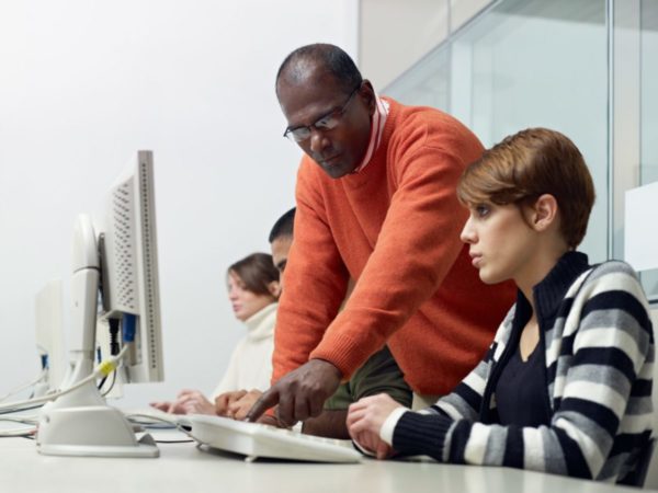 An instructor helping a computer student