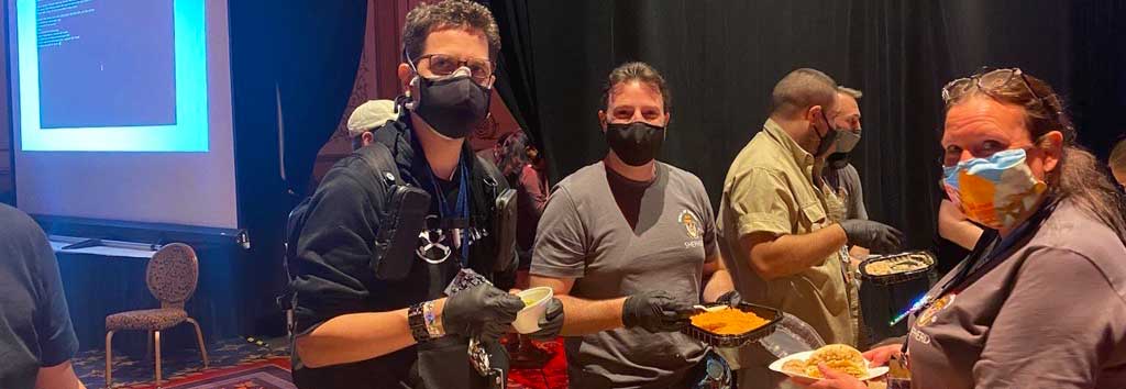 Aries Security CEO and founder Brian Markus, with DEF CON founder Jeff Moss (also known as The Dark Tangent) serving food to volunteers.