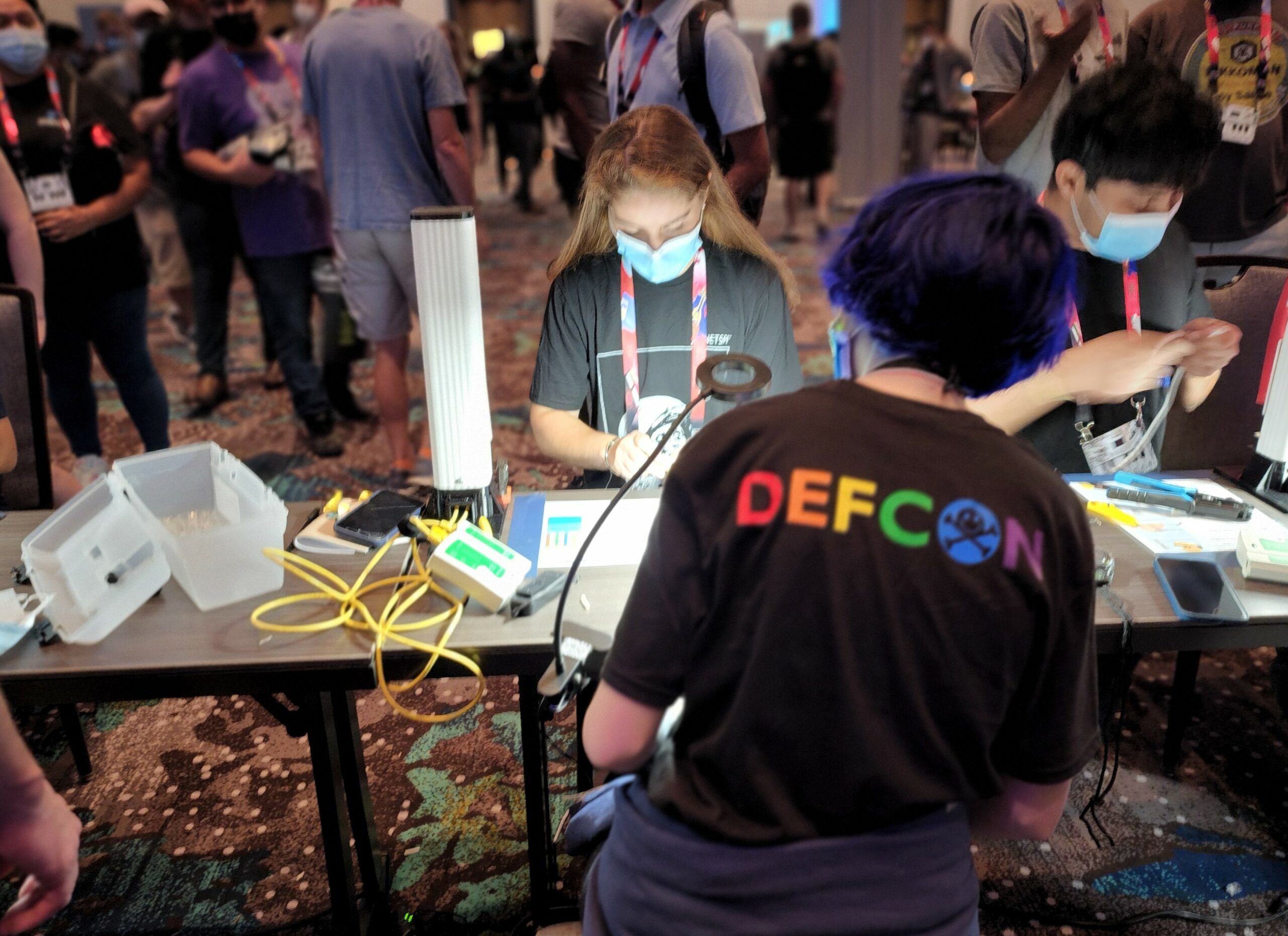 Hackers learning to make network cables in the HardWired challenge.